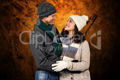 Composite image of winter couple enjoying hot drinks