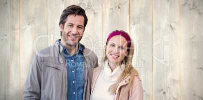 Composite image of smiling couple looking at camera