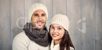 Composite image of smiling couple looking at camera