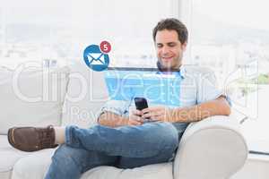 Composite image of cheerful man sitting on the couch using his s