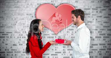 Composite image of excited young couple holding gift box