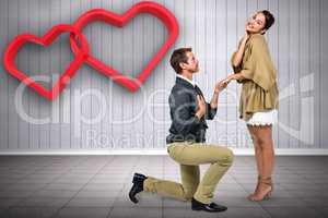 Composite image of man proposing woman while kneeling