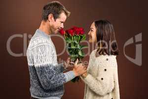 Composite image of romantic couple holding red roses