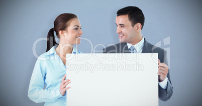 Composite image of young business partners presenting sign