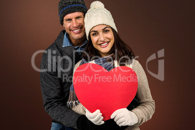 Composite image of festive couple in winter clothes