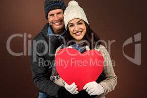 Composite image of festive couple in winter clothes