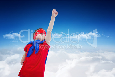 Composite image of masked boy pretending to be superhero on whit