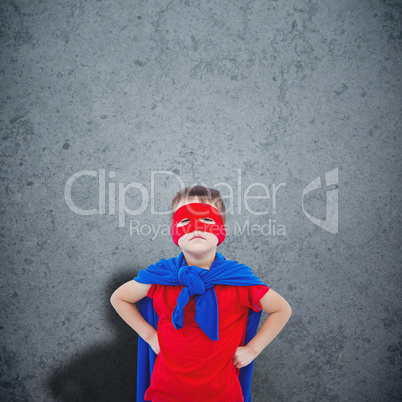 Composite image of masked boy pretending to be superhero