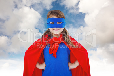 Composite image of masked girl pretending to be superhero