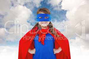 Composite image of masked girl pretending to be superhero