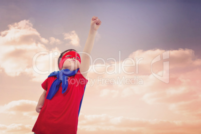Composite image of masked boy pretending to be superhero on whit