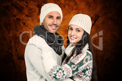 Composite image of smiling couple hugging and looking at camera