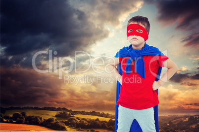 Composite image of masked boy pretending to be superhero