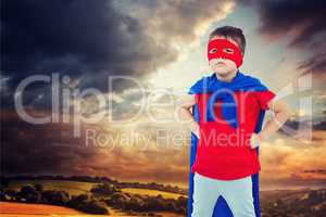 Composite image of masked boy pretending to be superhero