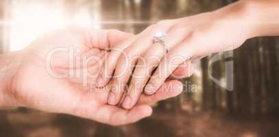 Composite image of close-up of couple holding hands