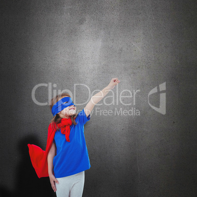 Composite image of masked girl pretending to be superhero