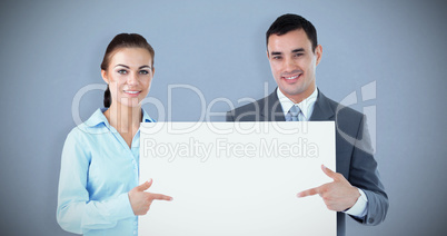 Composite image of business partners presenting sign together