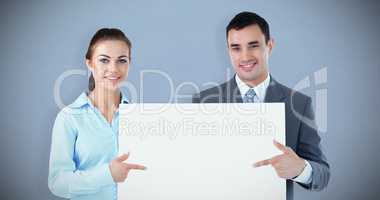 Composite image of business partners presenting sign together