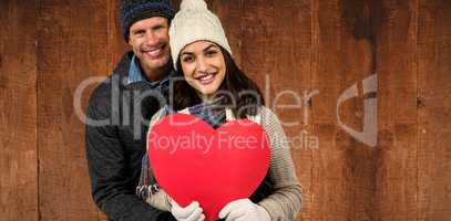 Composite image of festive couple in winter clothes