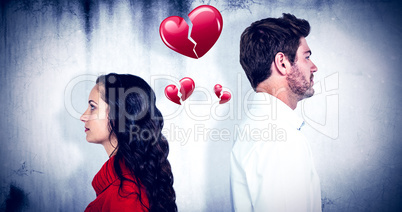 Composite image of couple standing back to back after arguing