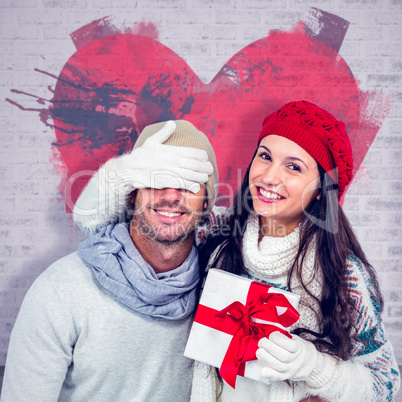 Composite image of smiling woman covering partners eyes and hold