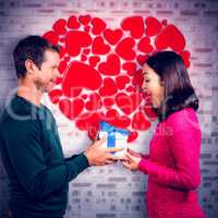 Composite image of excited girlfriend taking gift from boyfriend