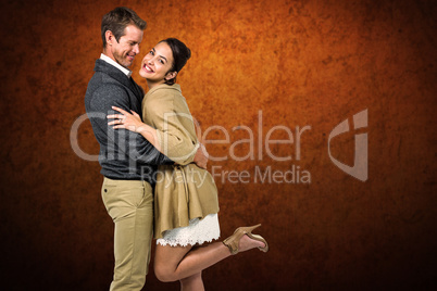 Composite image of full length of romantic couple hugging