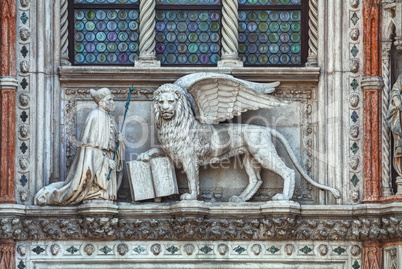 Winged lion on facade of the bell tower at San Marco square in V