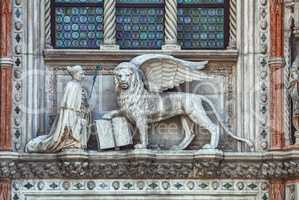 Winged lion on facade of the bell tower at San Marco square in V