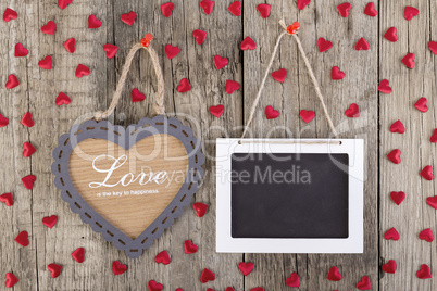 Empty wooden blackboard sign and heart shape frame