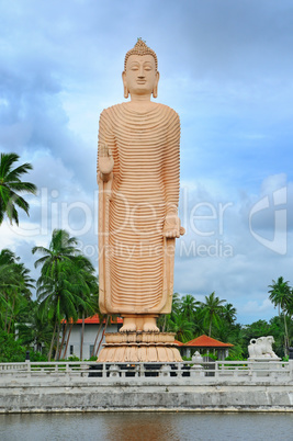 Buddha statue in full growth on a background of sky