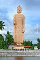 Buddha statue in full growth on a background of sky