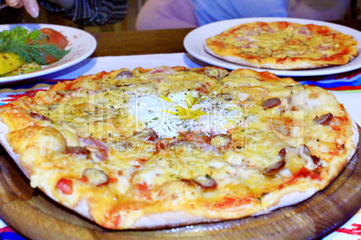 pizza with appetizing stuffing in pizzeria