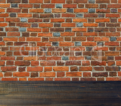 wall from the red brickes and dark wooden floor