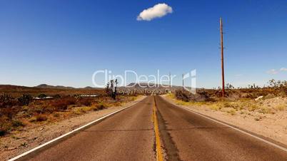 Long and empty road through Arizona desert .