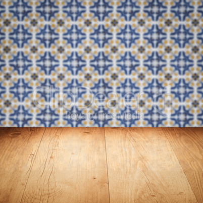 Wood table top and blur vintage ceramic tile pattern wall Wood table top and blur vintage ceramic tile pattern wall