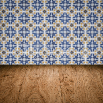 Wood table top and blur vintage ceramic tile pattern wall