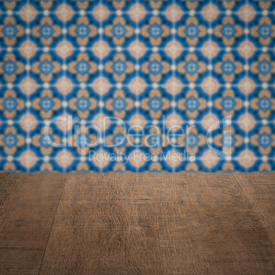 Wood table top and blur vintage ceramic tile pattern wall