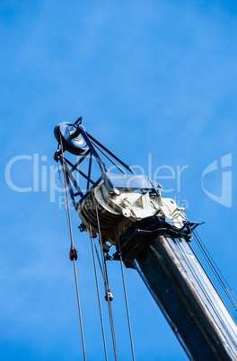 Large heavy industrial pulleys and cables at top of crane, verti