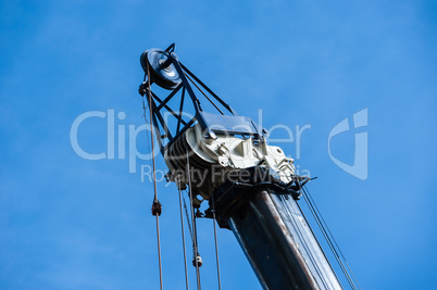 Large heavy industrial pulleys and cables at top of crane, horiz