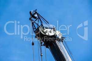 Large heavy industrial pulleys and cables at top of crane, horiz