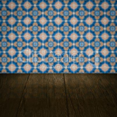 Wood table top and blur vintage ceramic tile pattern wall