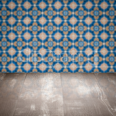 Wood table top and blur vintage ceramic tile pattern wall