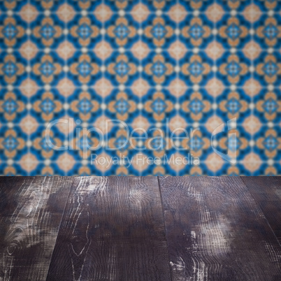 Wood table top and blur vintage ceramic tile pattern wall