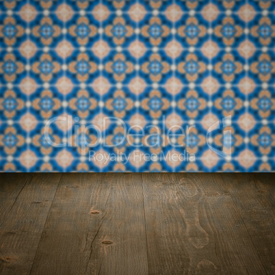 Wood table top and blur vintage ceramic tile pattern wall Wood table top and blur vintage ceramic tile pattern wall