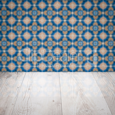 Wood table top and blur vintage ceramic tile pattern wall