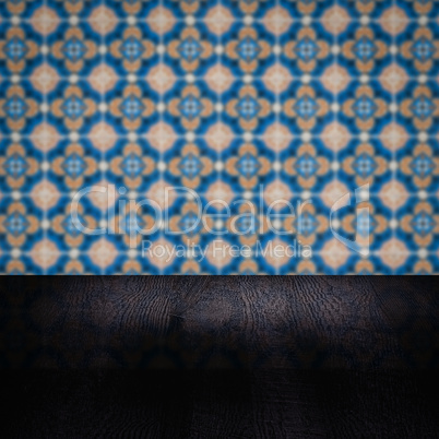 Wood table top and blur vintage ceramic tile pattern wall