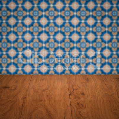 Wood table top and blur vintage ceramic tile pattern wall