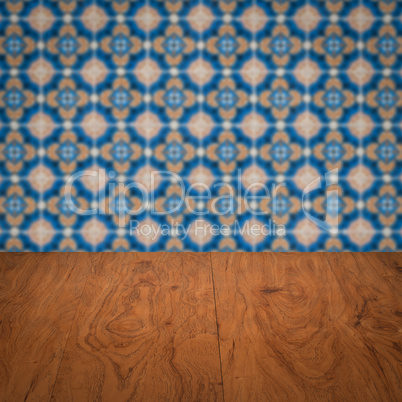 Wood table top and blur vintage ceramic tile pattern wall Wood table top and blur vintage ceramic tile pattern wall