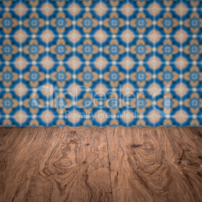 Wood table top and blur vintage ceramic tile pattern wall